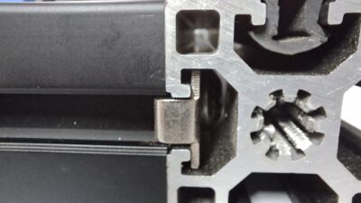 Close-up of 45x90 T-slot aluminium extrusion end showing internal slot geometry and connection point with fastener.